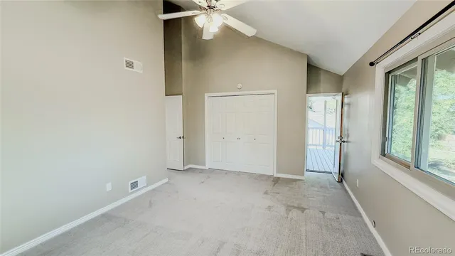 an empty room with windows and closet