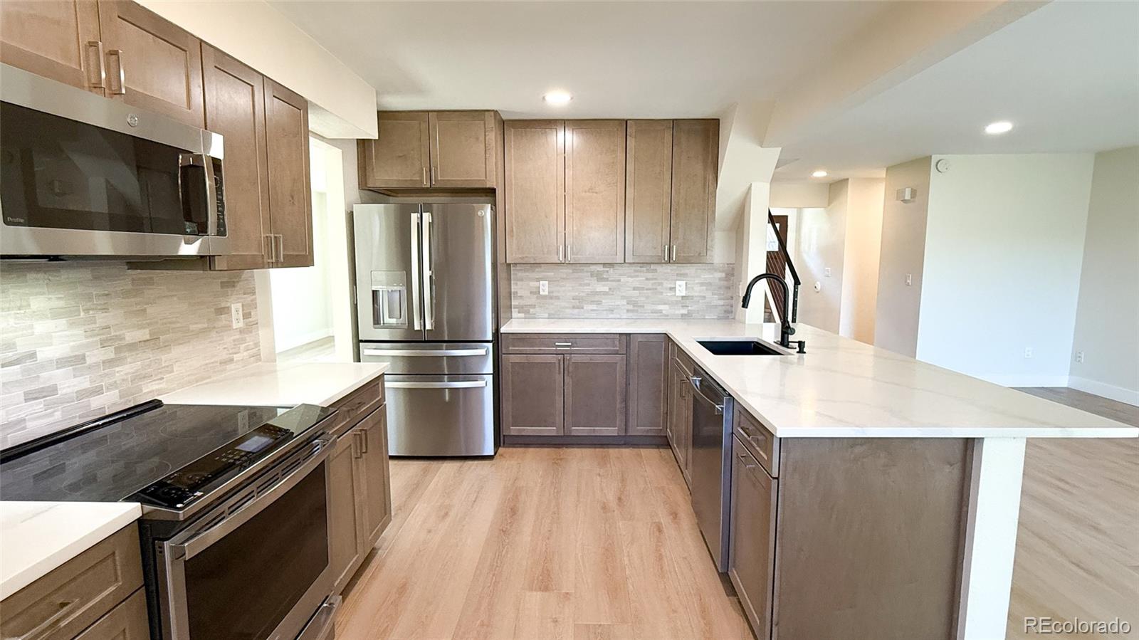 15789 Sandtrap Way Morrison, CO 80465 - Photo 14 of 42 a kitchen with a sink stove and refrigerator