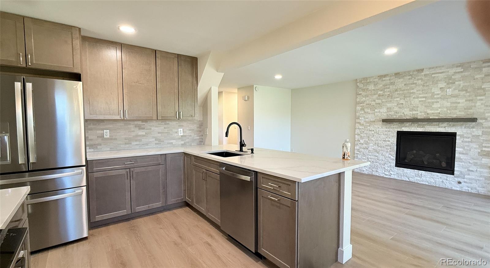 15789 Sandtrap Way Morrison, CO 80465 - Photo 16 of 42 a kitchen with a sink stove and refrigerator