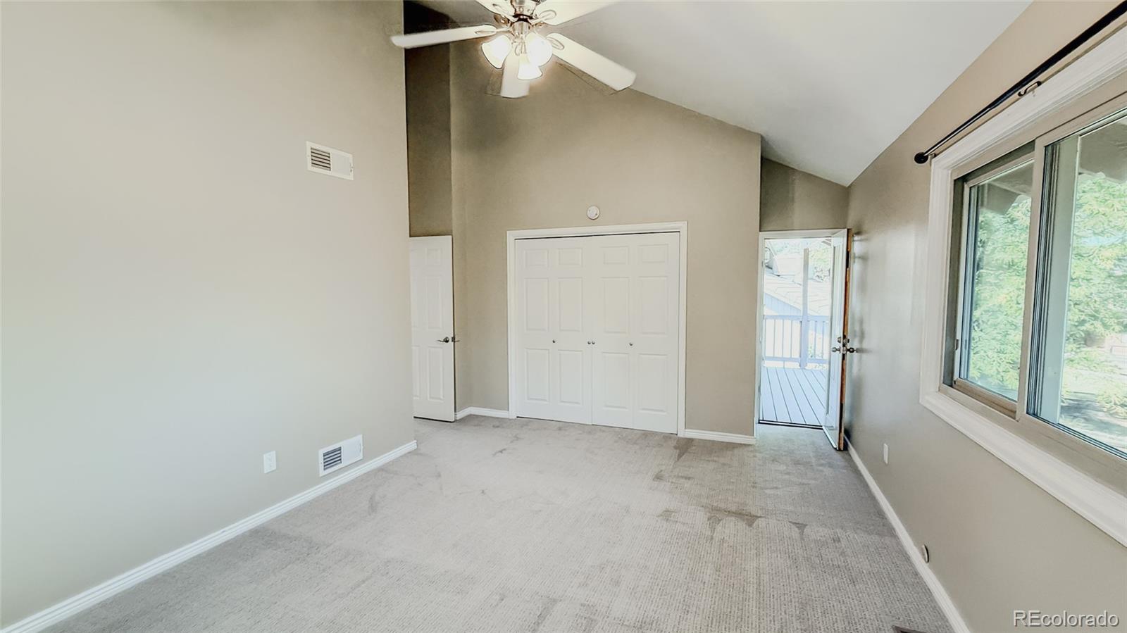 15789 Sandtrap Way Morrison, CO 80465 - Photo 18 of 42 an empty room with windows and closet