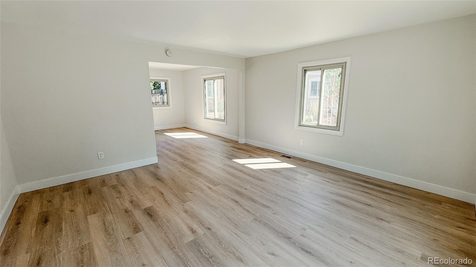 15789 Sandtrap Way Morrison, CO 80465 - Photo 19 of 34 a view of an empty room with wooden floor and a window