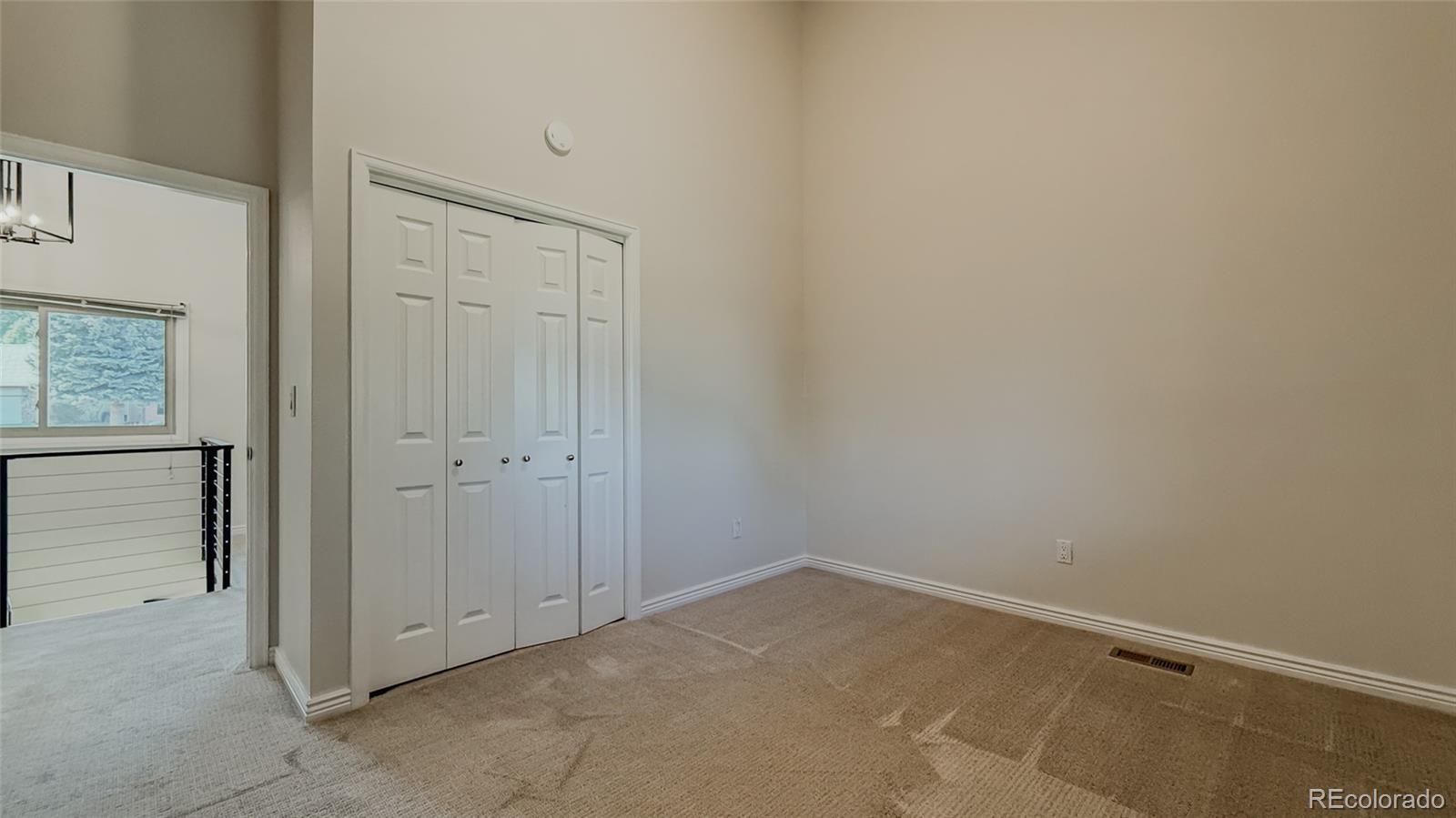 15789 Sandtrap Way Morrison, CO 80465 - Photo 22 of 42 an empty room with windows