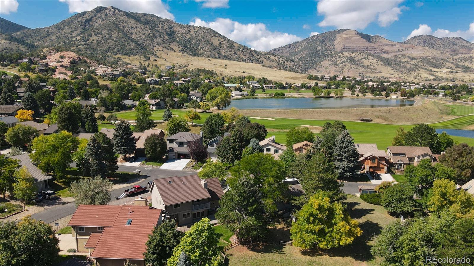 15789 Sandtrap Way Morrison, CO 80465 - Photo 24 of 34 an aerial view of a residential houses with outdoor space and trees all around