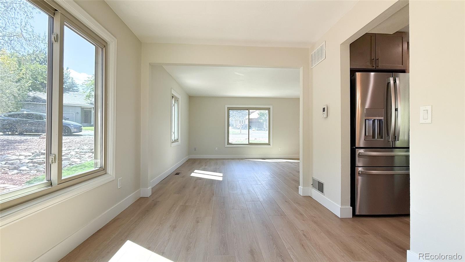 15789 Sandtrap Way Morrison, CO 80465 - Photo 24 of 42 a view of a hallway with wooden floor and a living room