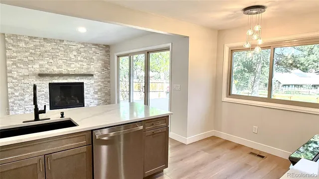 a kitchen with stainless steel appliances kitchen island granite countertop a refrigerator and a stove top oven