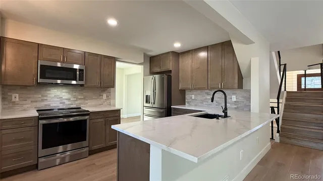 a view of a kitchen with a sink and a large window