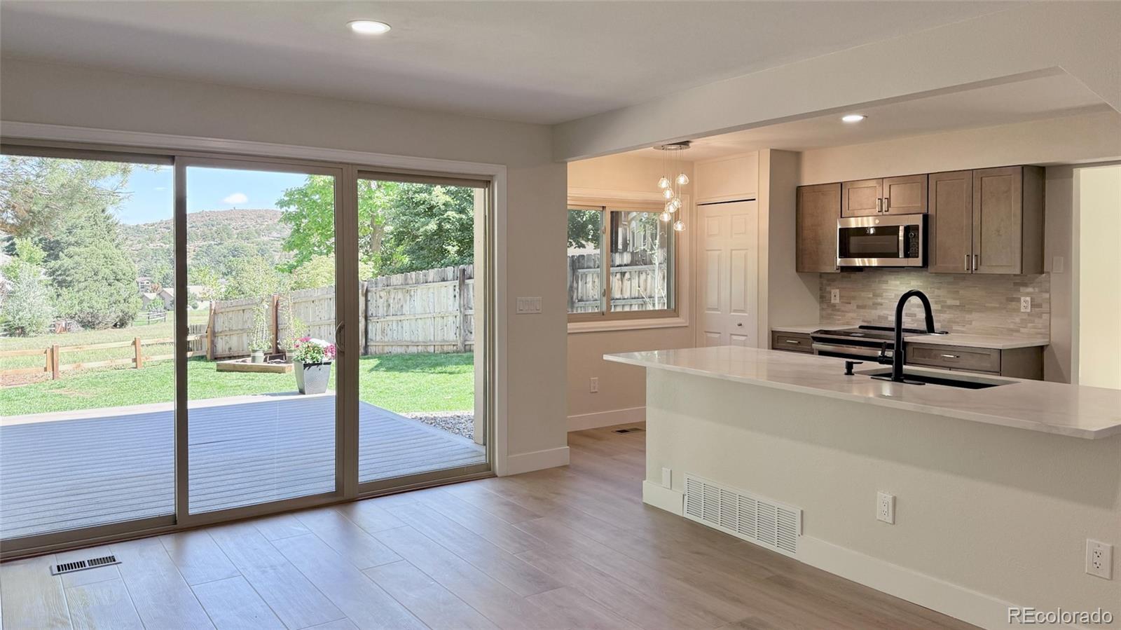 15789 Sandtrap Way Morrison, CO 80465 - Photo 6 of 34 a view of a kitchen with a sink and a large window