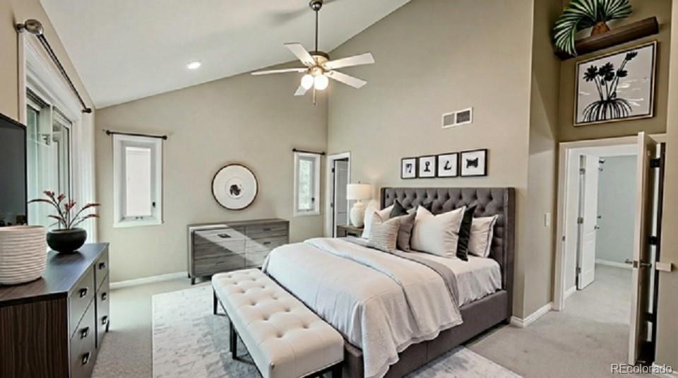 15789 Sandtrap Way Morrison, CO 80465 - Photo 6 of 42 a bedroom with a bed and a chandelier
