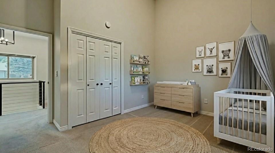 15789 Sandtrap Way Morrison, CO 80465 - Photo 10 of 42 a room with a baby crib and dresser