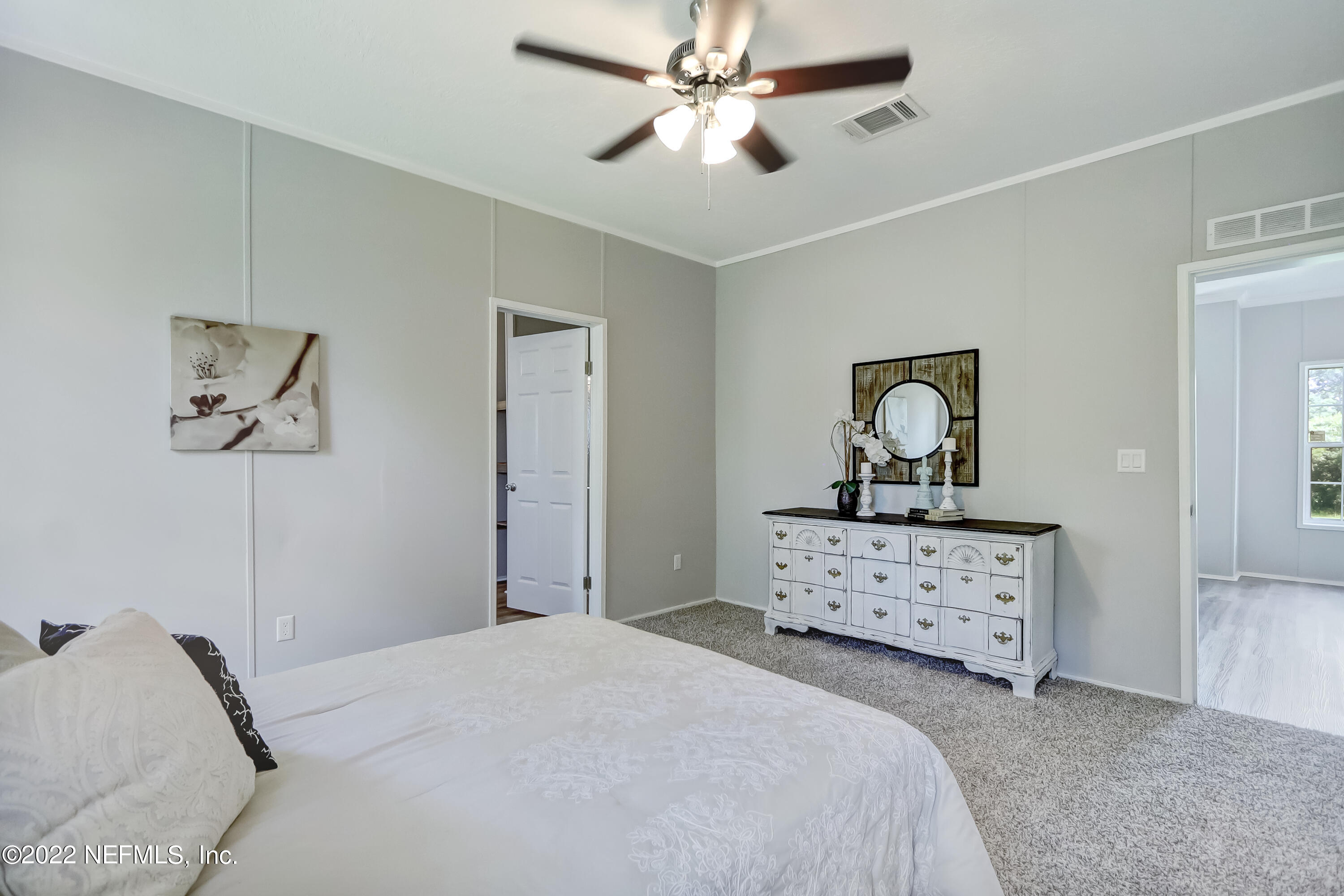 54267 Heller Road Callahan, FL 32011 - Photo 24 of 37 a bedroom with a bed and a dresser