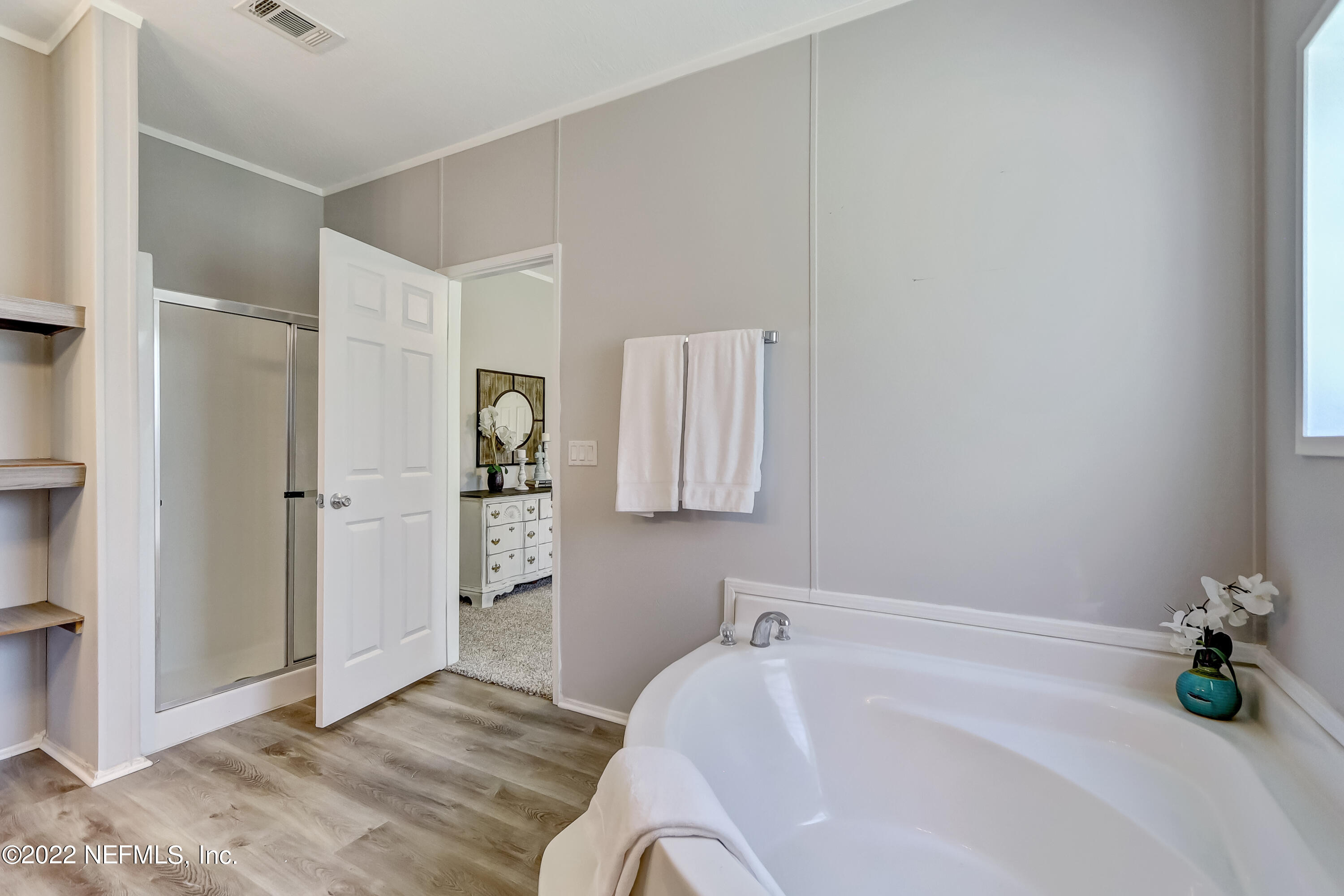 54267 Heller Road Callahan, FL 32011 - Photo 25 of 37 a bathroom with a tub shower and a sink