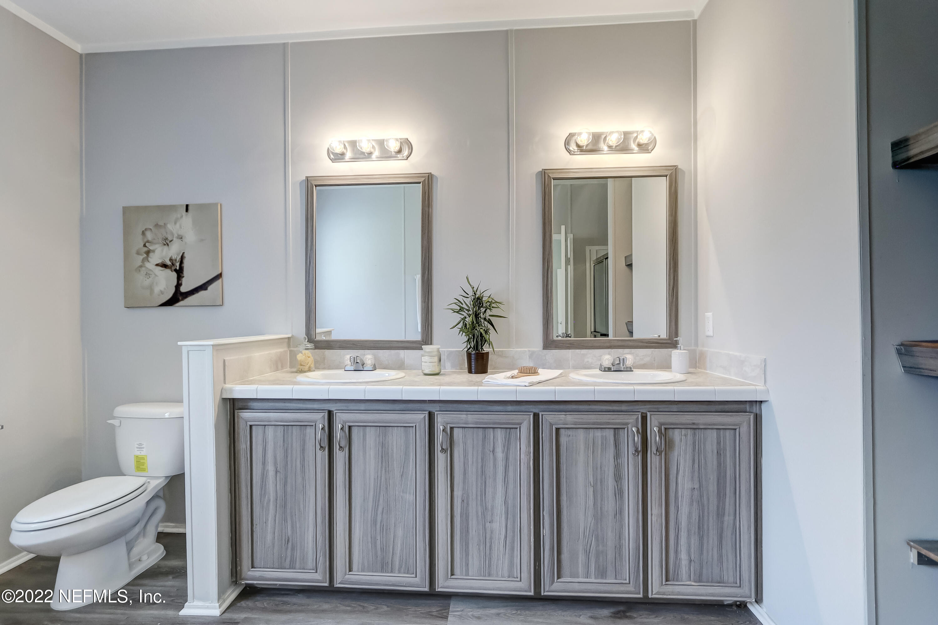 54267 Heller Road Callahan, FL 32011 - Photo 26 of 37 a bathroom with a toilet a sink and mirror