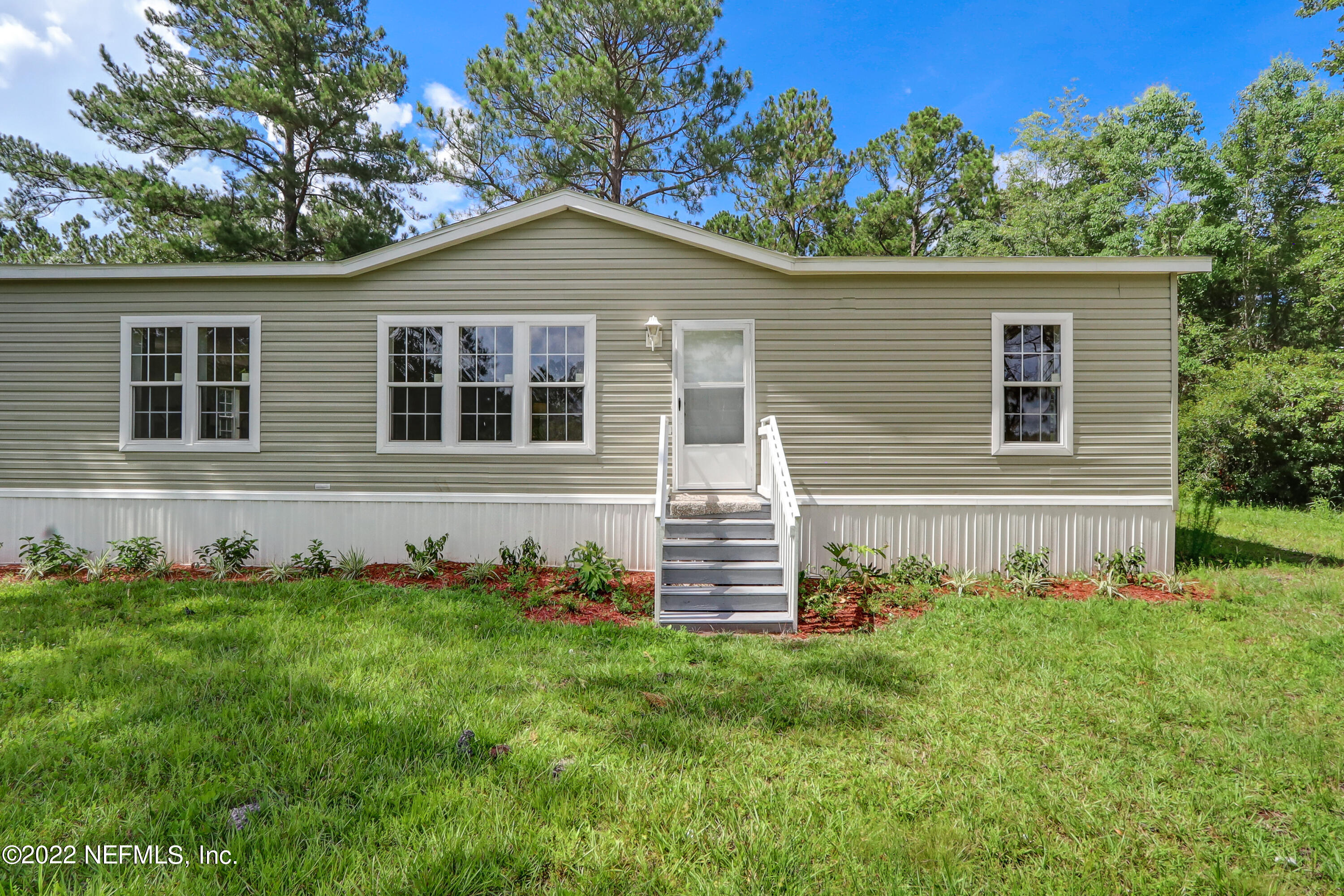54267 Heller Road Callahan, FL 32011 - Photo 3 of 37 a front view of a house with a garden