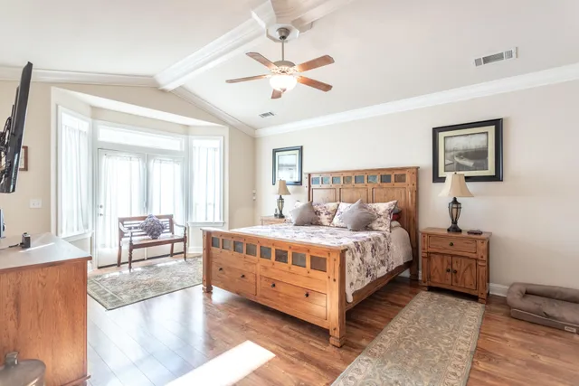 a bed room with a bed and a chandelier
