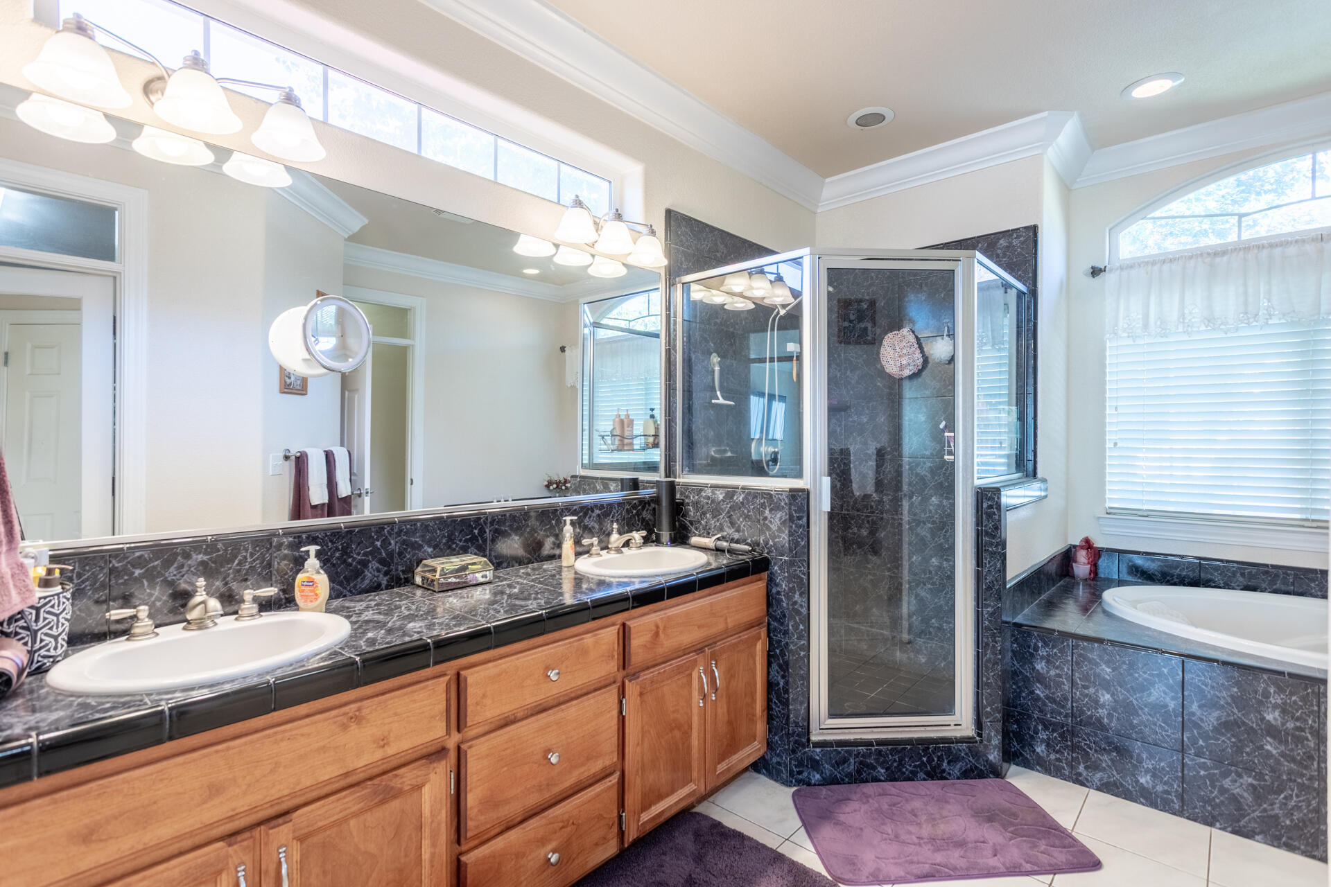 2877 Green Riffle Road Redding, CA 96002 - Photo 17 of 37 a spacious bathroom with a granite countertop sink mirror and shower