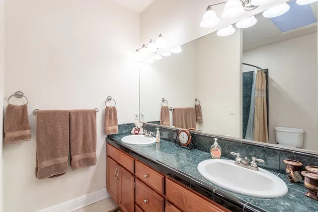 a bathroom with a double vanity sink and a mirror