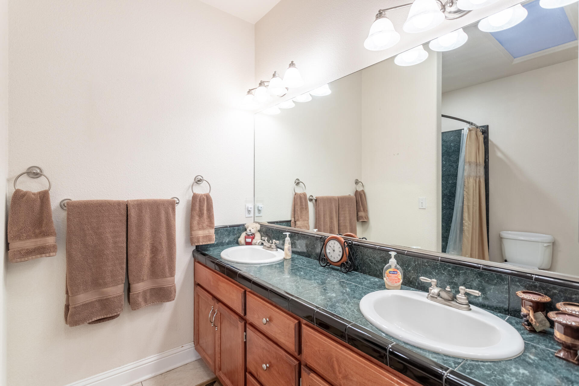 2877 Green Riffle Road Redding, CA 96002 - Photo 21 of 37 a bathroom with a double vanity sink and a mirror