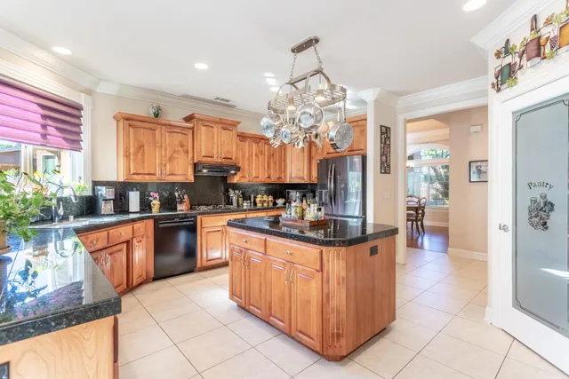 a kitchen with stainless steel appliances granite countertop a stove top oven a sink dishwasher and cabinets