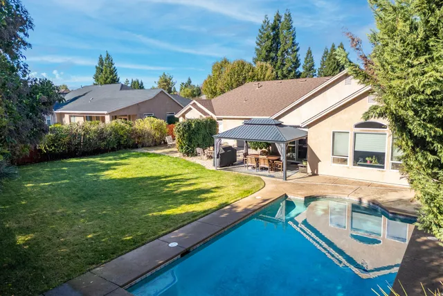 a view of a house with a yard patio and sitting area