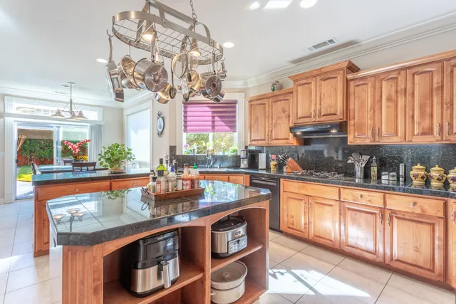 a kitchen with stainless steel appliances granite countertop a stove and cabinets