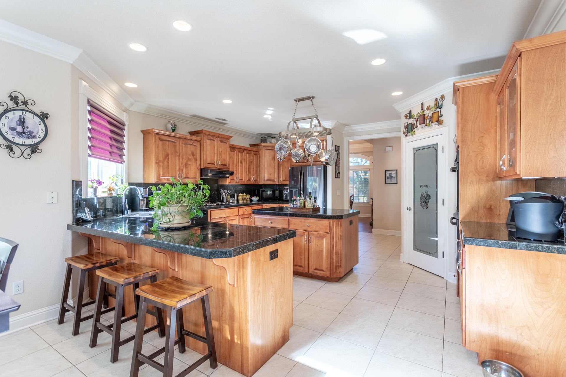 2877 Green Riffle Road Redding, CA 96002 - Photo 5 of 37 a kitchen with stainless steel appliances kitchen island granite countertop a table and chairs in it