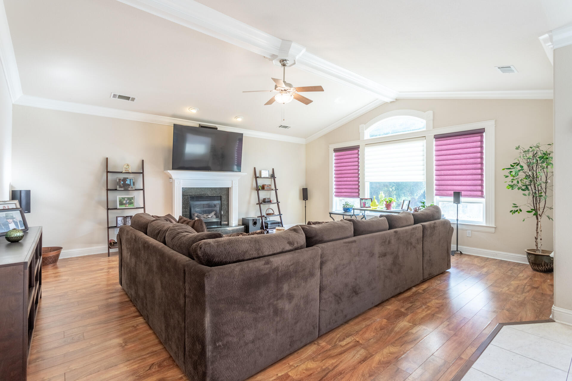 2877 Green Riffle Road Redding, CA 96002 - Photo 10 of 37 a living room with furniture a fireplace and a flat screen tv