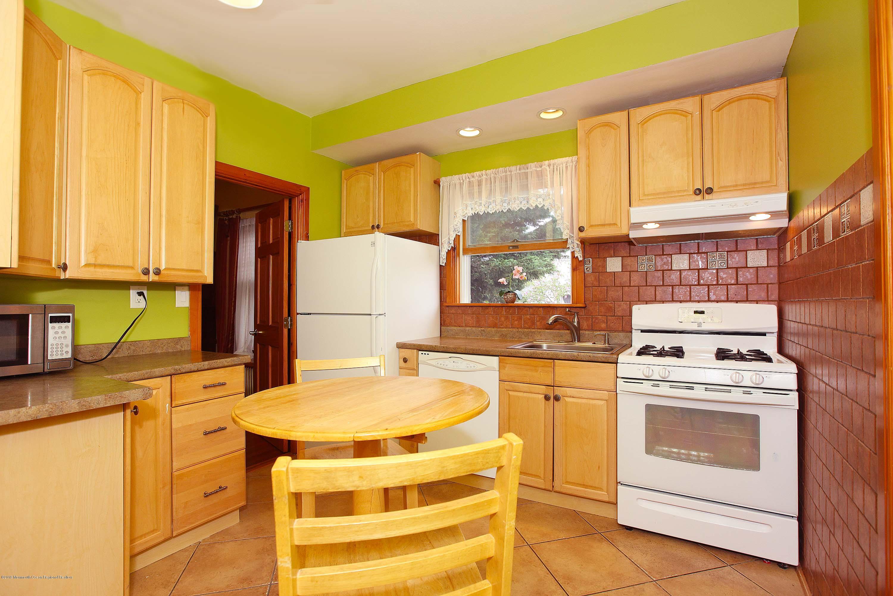 210 Hillside Road Linden, NJ 07036 - Photo 11 of 25 a kitchen with a stove a sink and a refrigerator