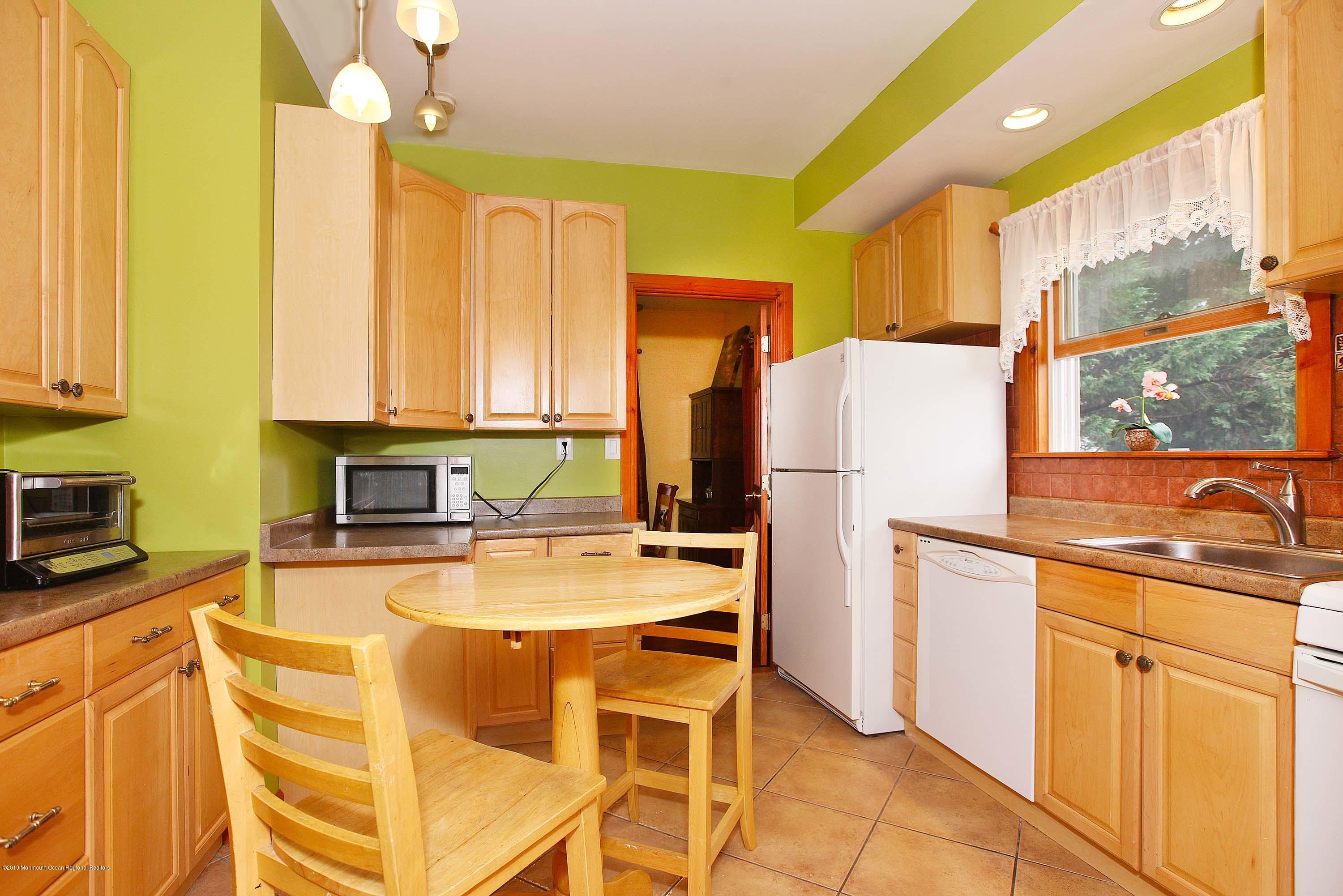 210 Hillside Road Linden, NJ 07036 - Photo 12 of 25 a kitchen with a refrigerator a stove a sink dishwasher and wooden cabinets with wooden floor
