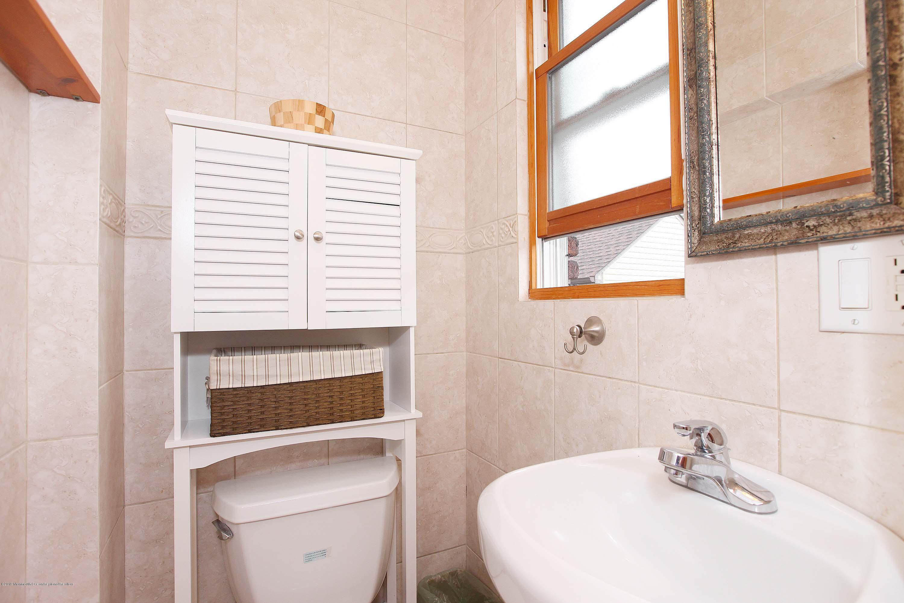 210 Hillside Road Linden, NJ 07036 - Photo 13 of 25 a bathroom with a sink a toilet and a window