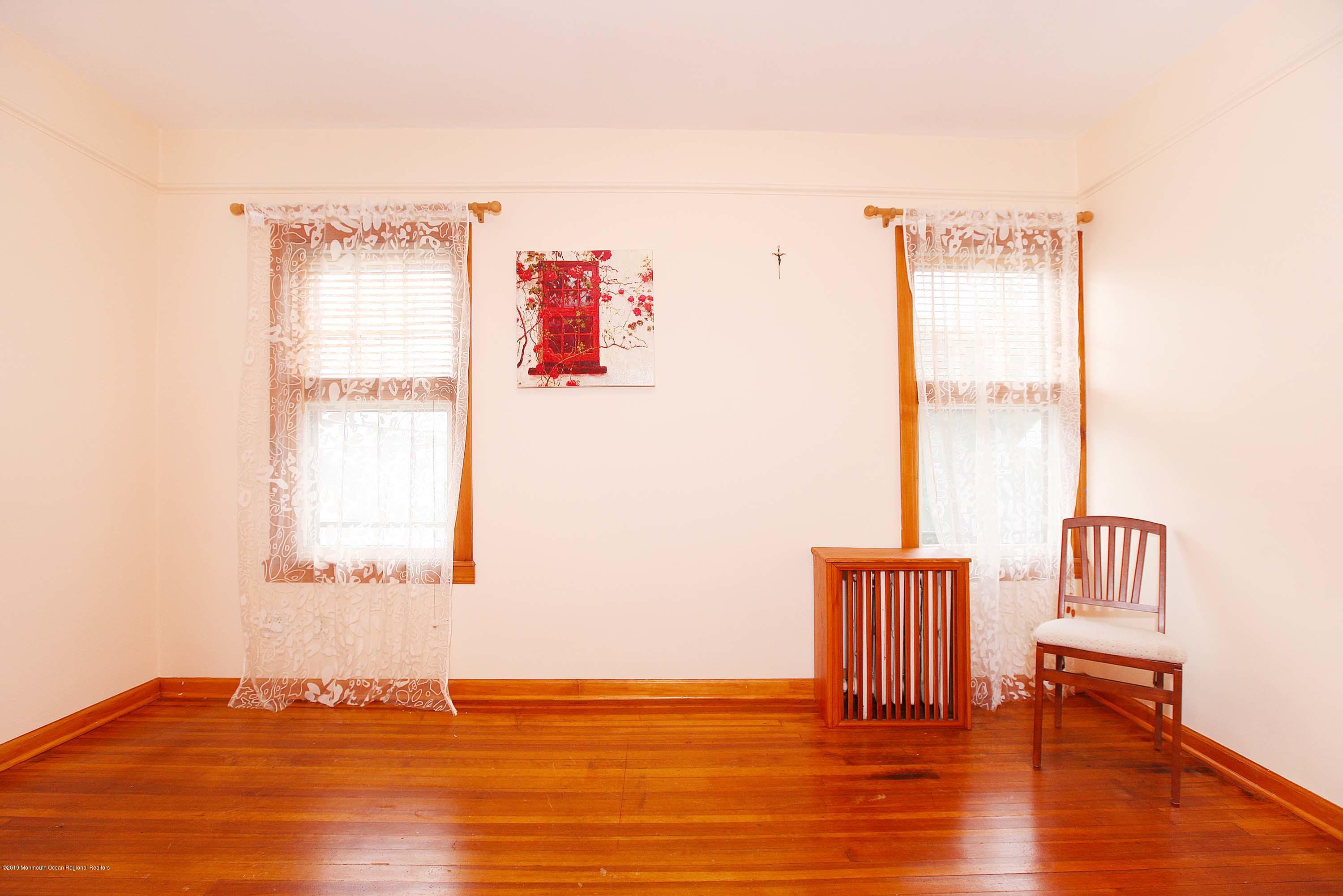210 Hillside Road Linden, NJ 07036 - Photo 15 of 25 a view of an empty room with wooden floor and a window