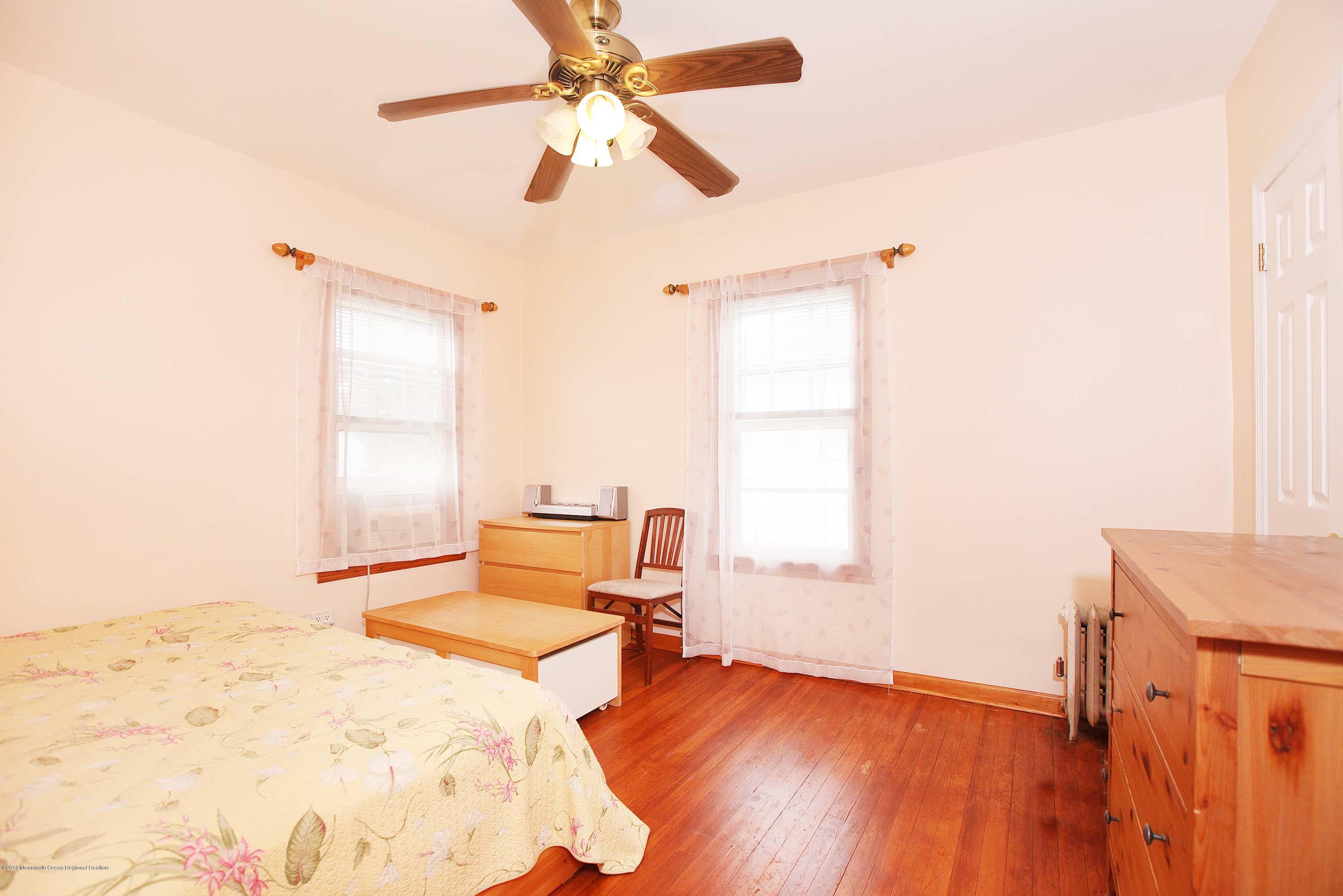210 Hillside Road Linden, NJ 07036 - Photo 18 of 25 a bedroom with a bed and wooden floor