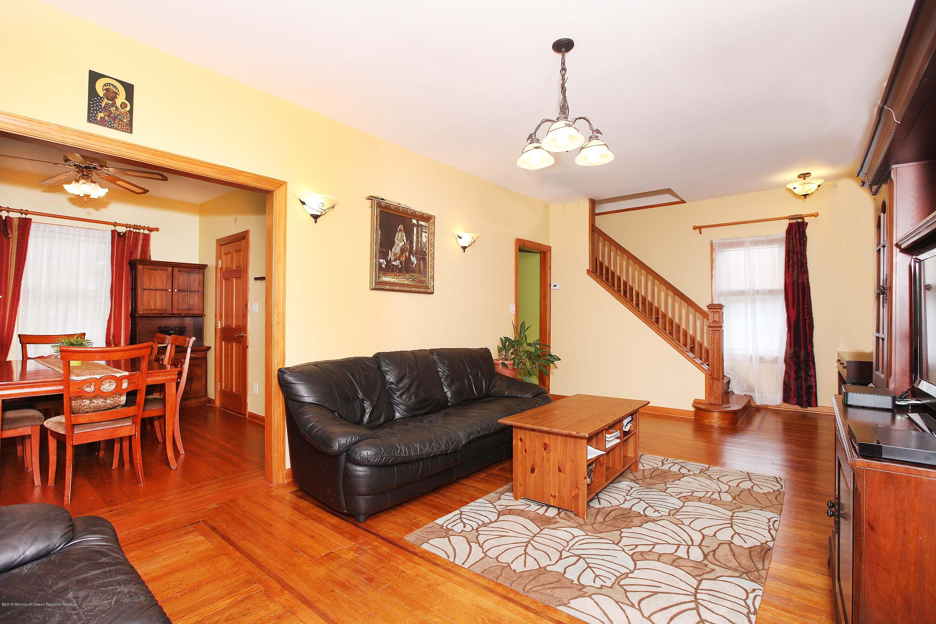 210 Hillside Road Linden, NJ 07036 - Photo 8 of 25 a living room with furniture a dining table and a chandelier