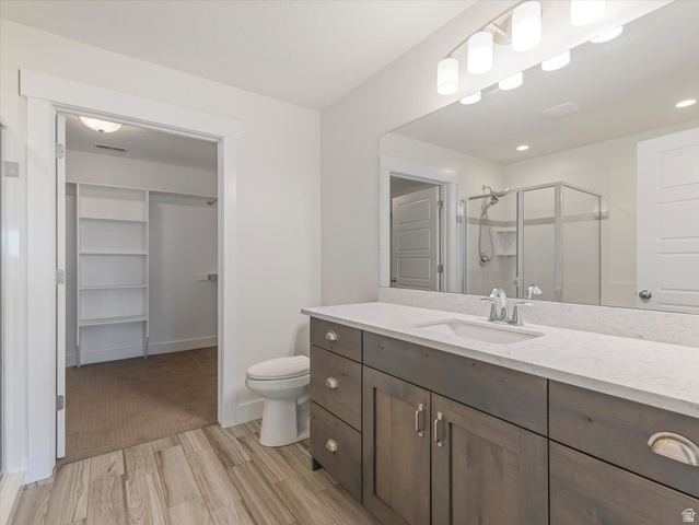 1278 South Grace Way Layton, UT 84041 - Photo 13 of 23 Modern bathroom featuring a wood-finish vanity with a light-toned countertop and an integrated sink