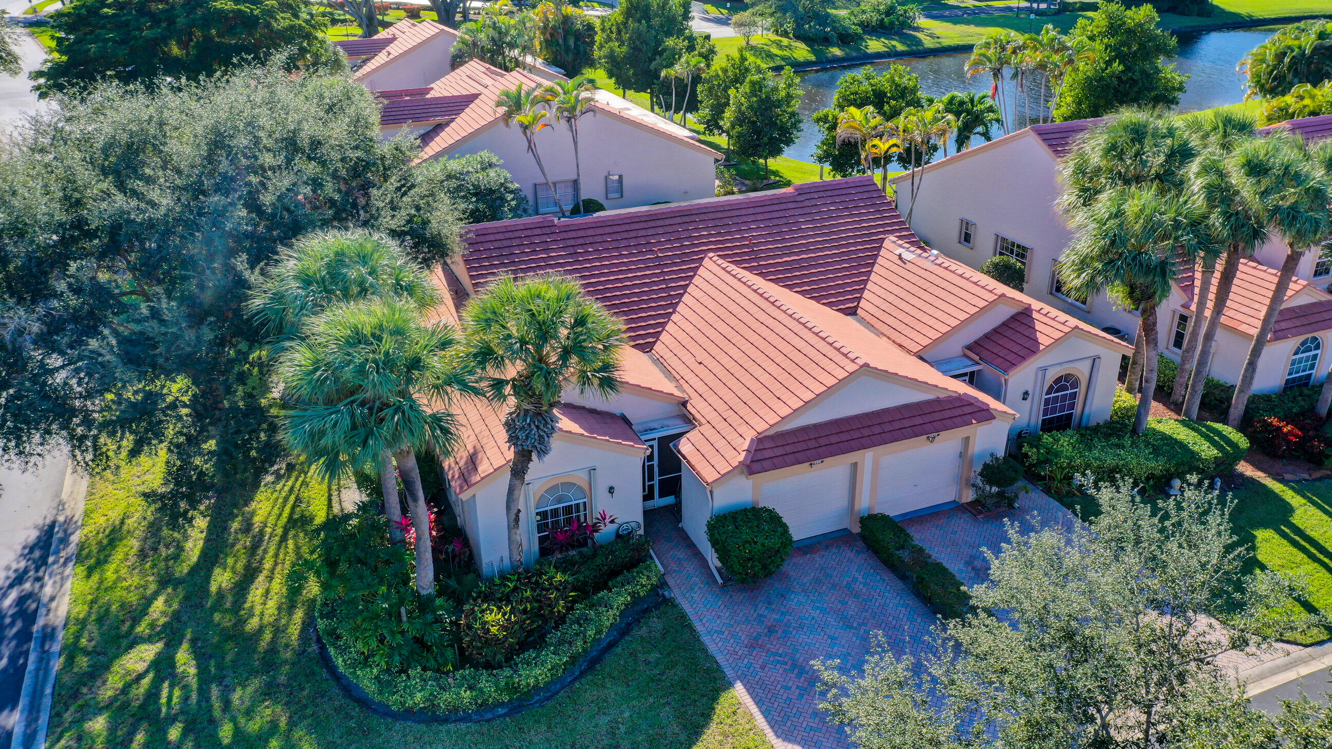 an aerial view of house with swimming pool and garden