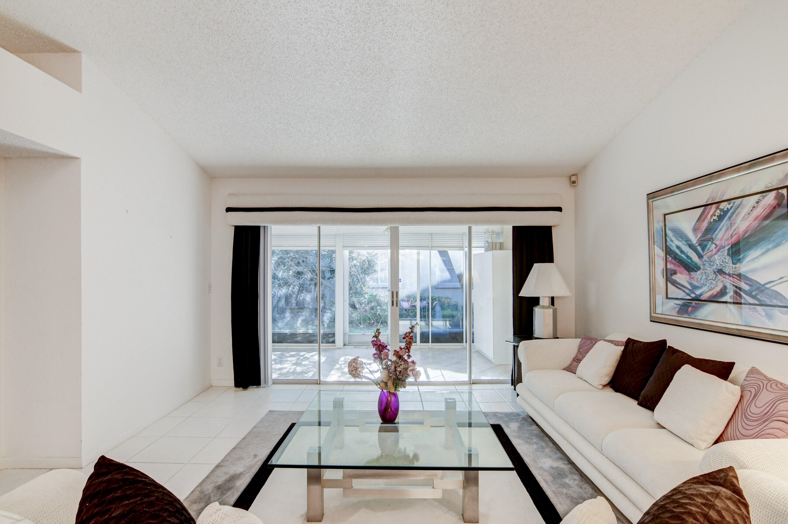 7566 Red Ruby Drive Delray Beach, FL 33446 - Photo 11 of 44 a living room with furniture or couch and a large window