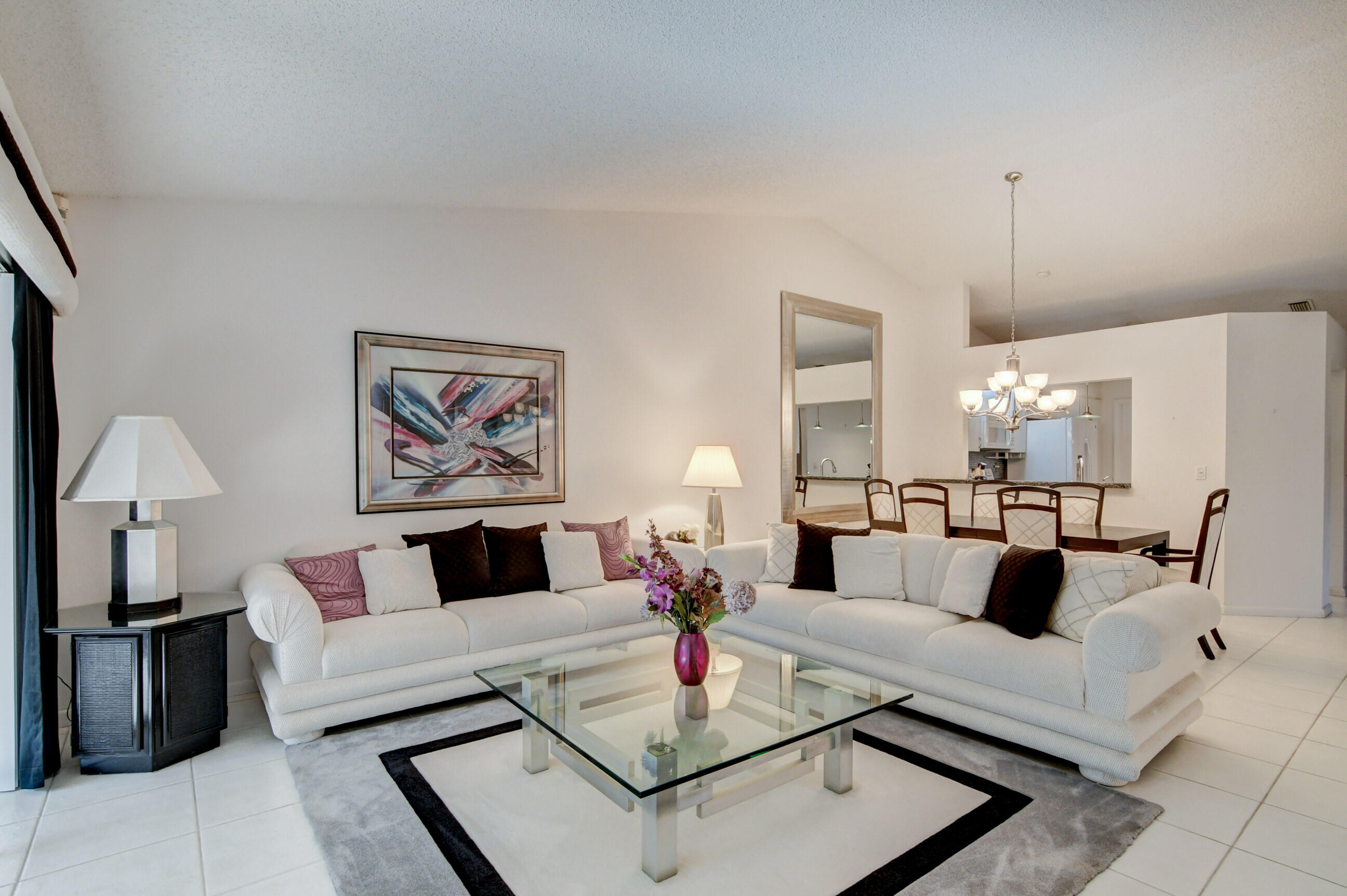 7566 Red Ruby Drive Delray Beach, FL 33446 - Photo 12 of 44 a living room with furniture and a chandelier