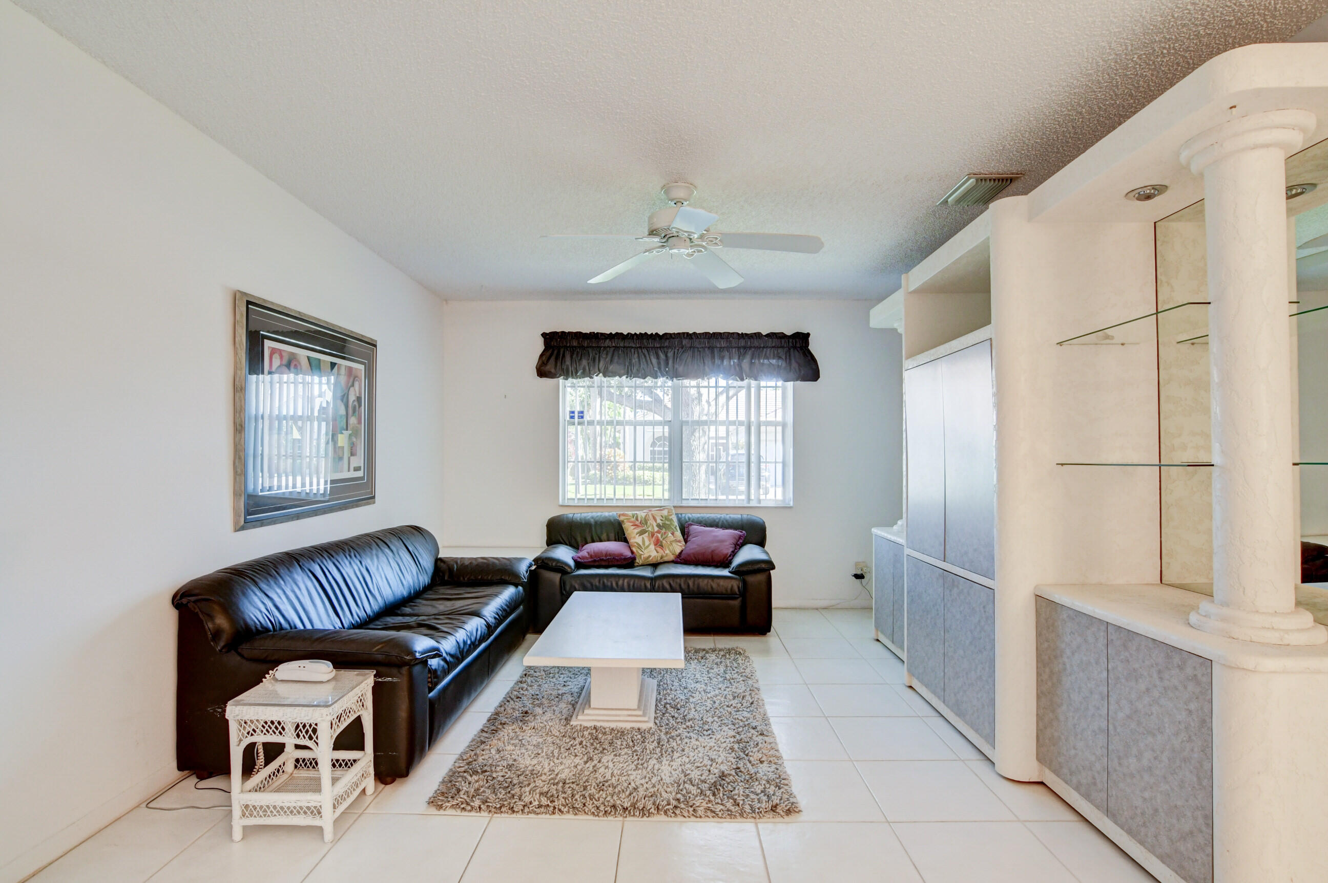 7566 Red Ruby Drive Delray Beach, FL 33446 - Photo 16 of 44 a living room with furniture and a window