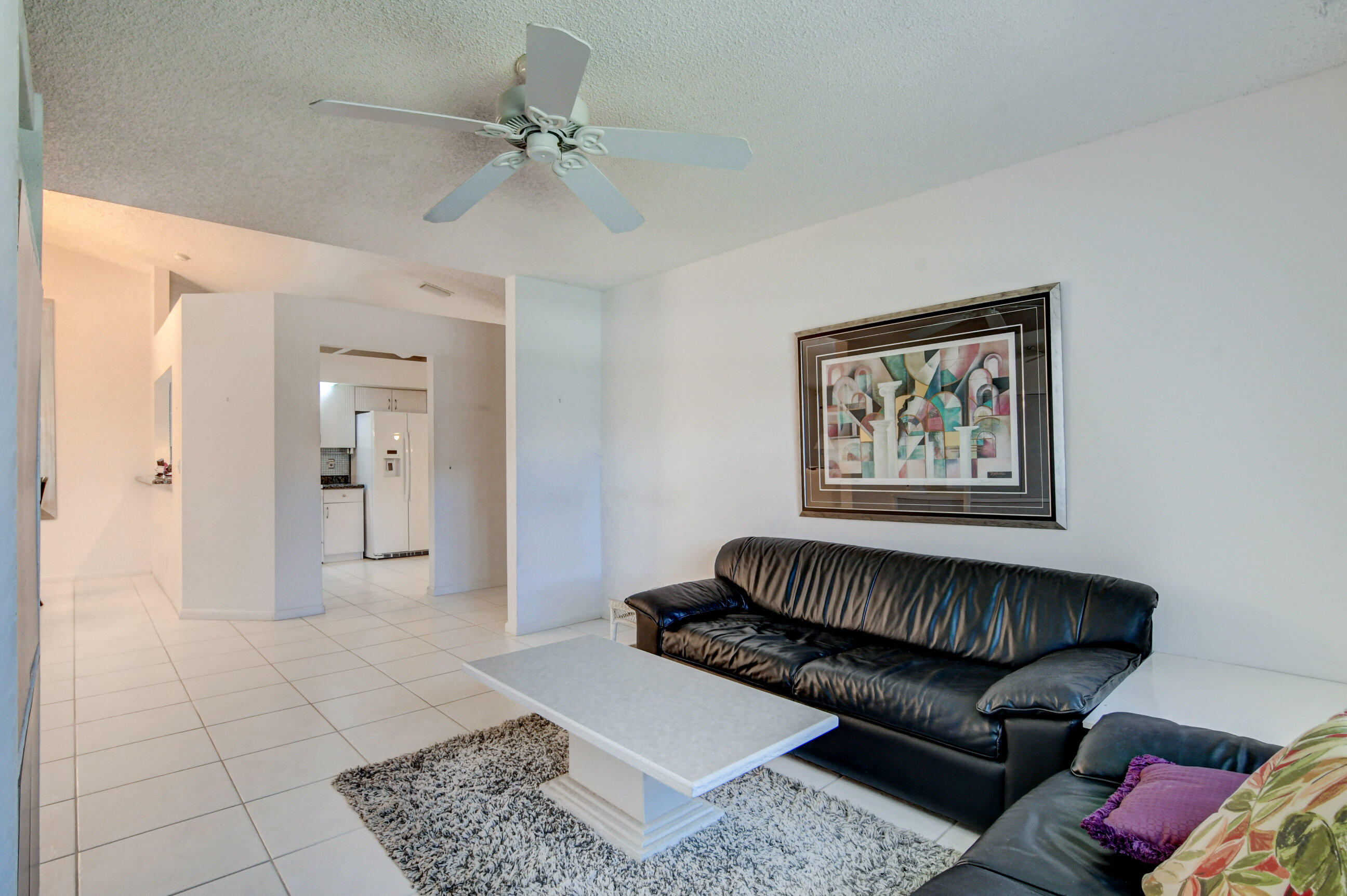 7566 Red Ruby Drive Delray Beach, FL 33446 - Photo 17 of 44 a living room with furniture and a rug