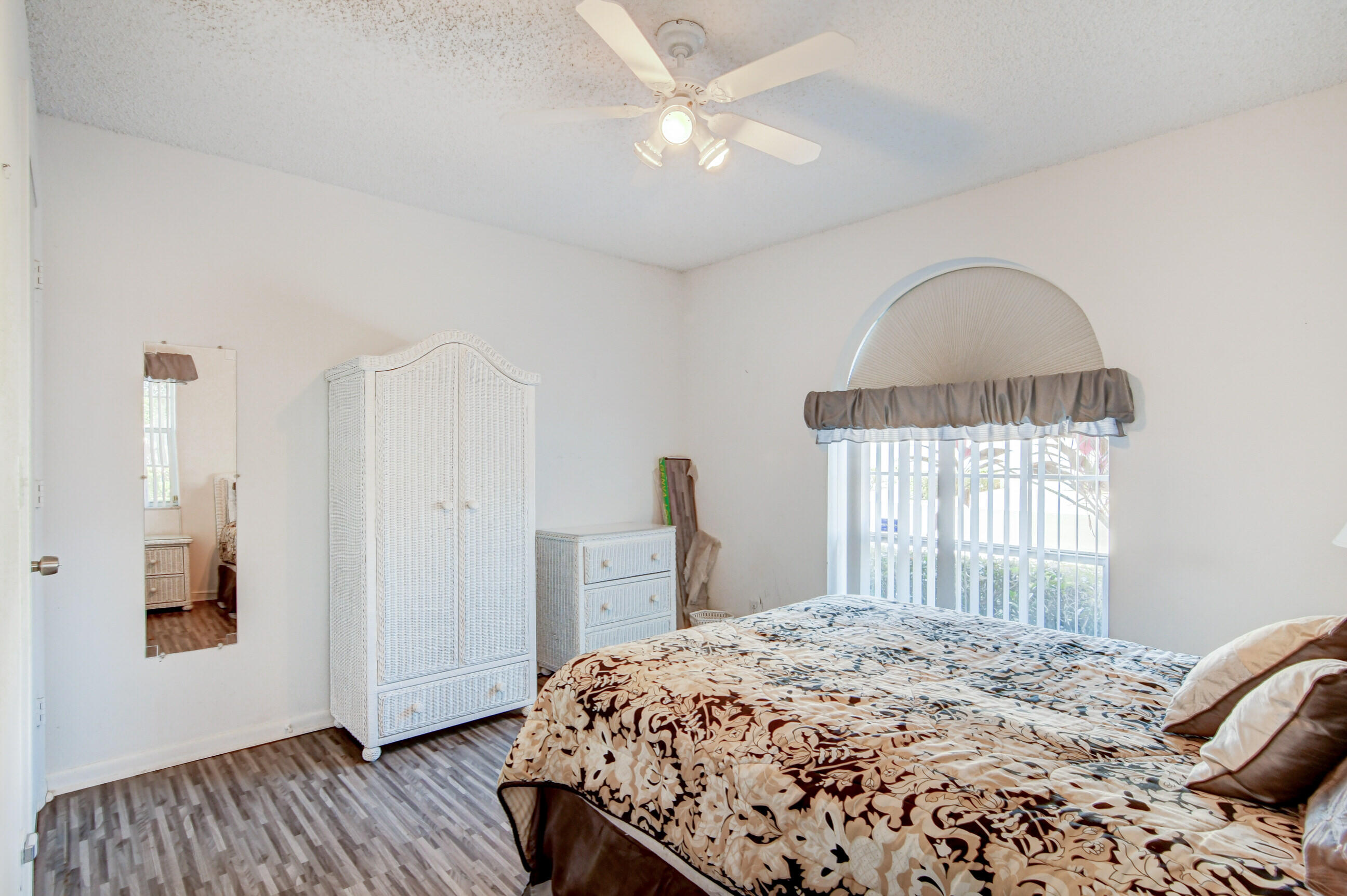 7566 Red Ruby Drive Delray Beach, FL 33446 - Photo 28 of 44 a bedroom with a bed and a window