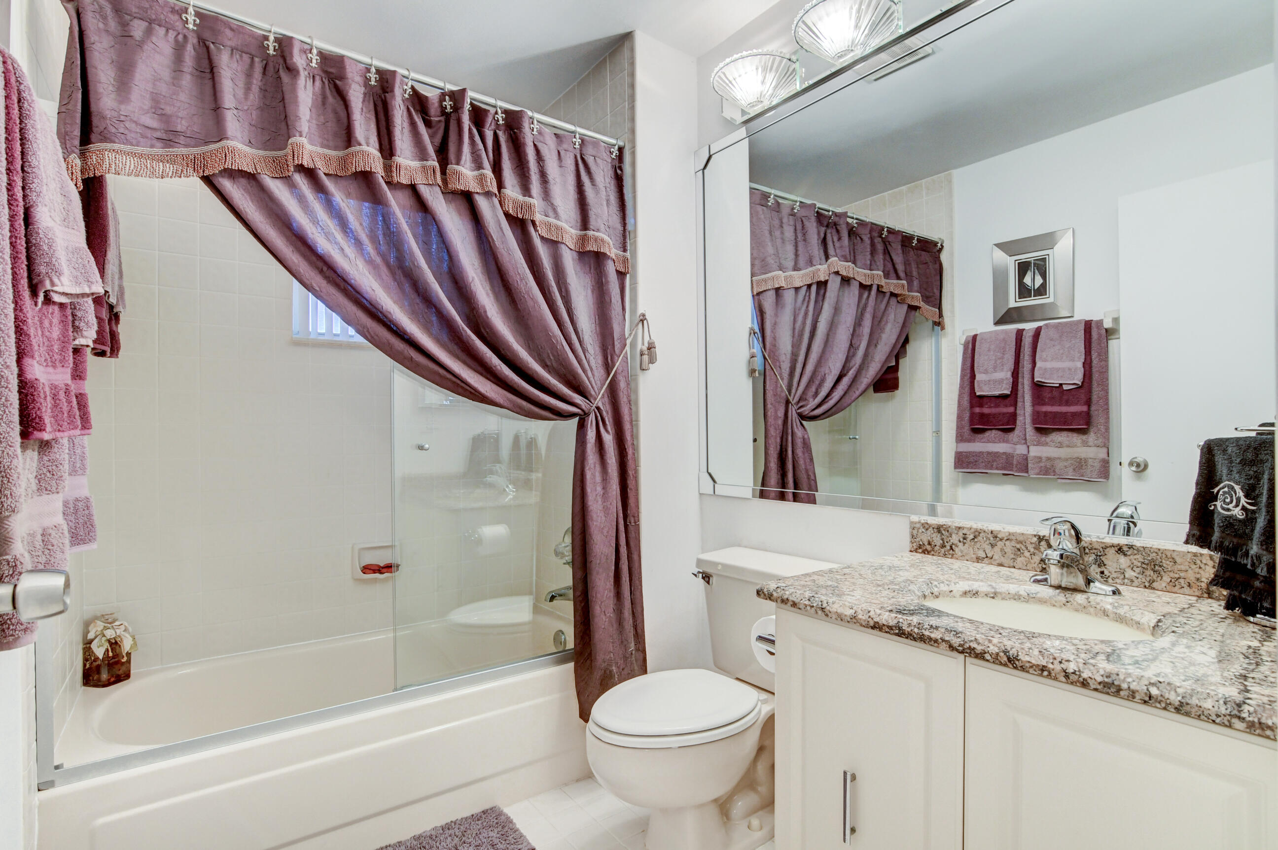 7566 Red Ruby Drive Delray Beach, FL 33446 - Photo 29 of 44 a bathroom with a granite countertop sink and a mirror