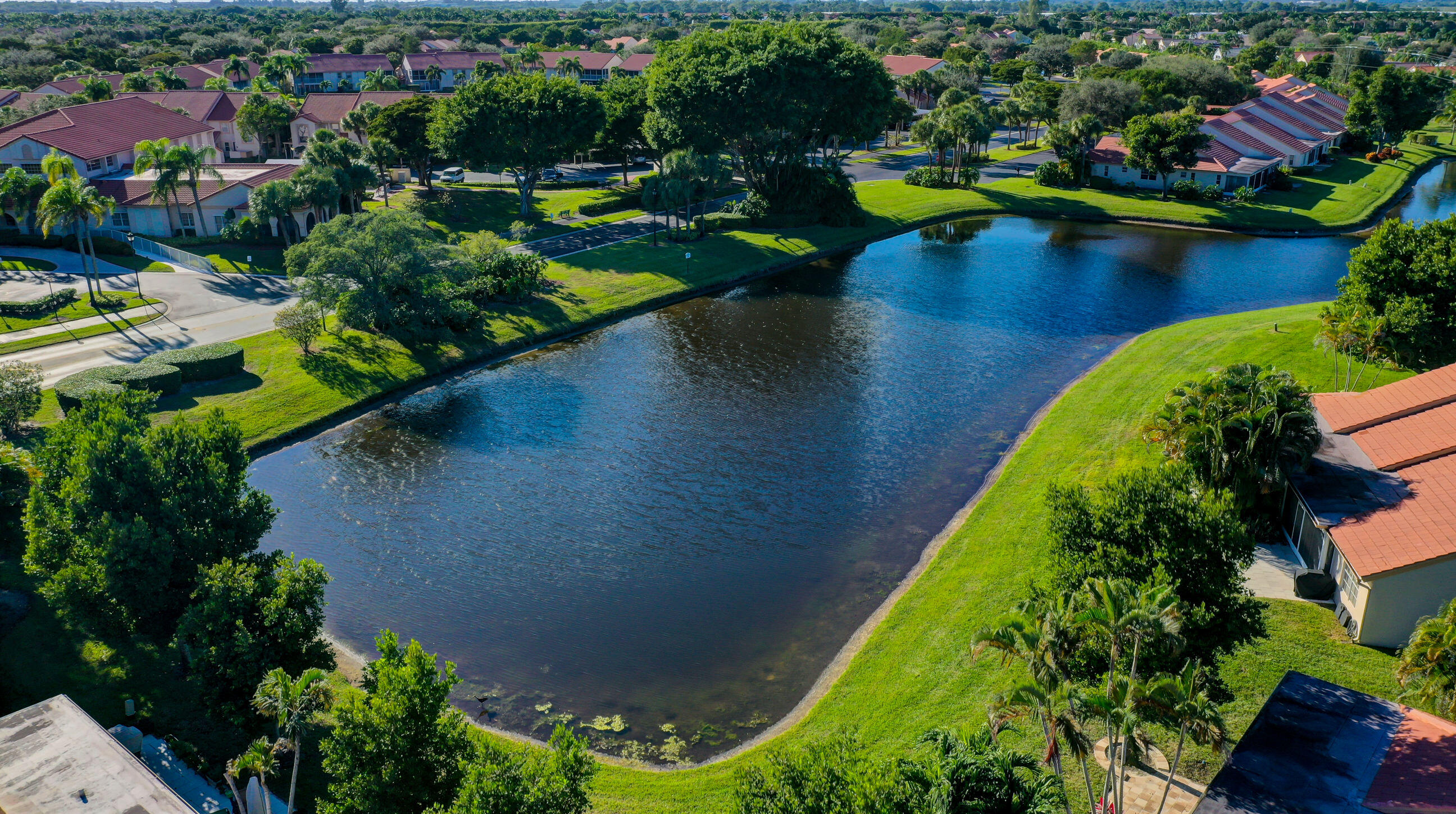 7566 Red Ruby Drive Delray Beach, FL 33446 - Photo 3 of 44 an aerial view of a house with swimming pool tennis courts and ocean view