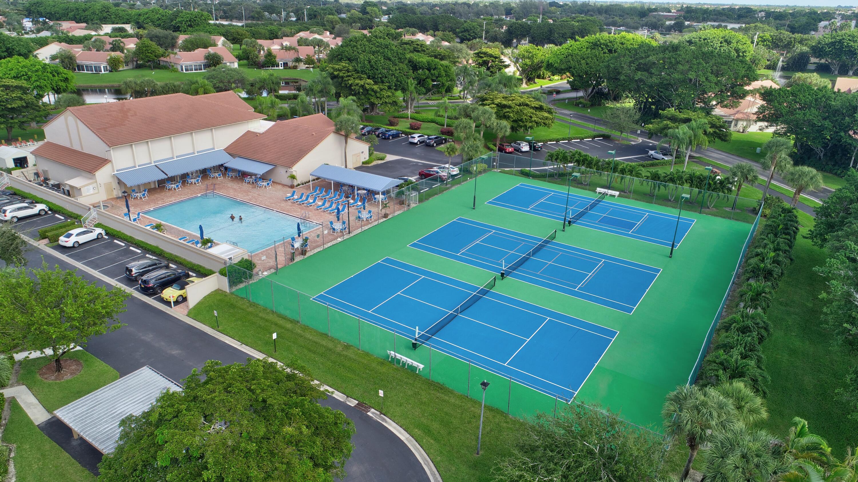 7566 Red Ruby Drive Delray Beach, FL 33446 - Photo 36 of 44 an aerial view of a tennis ground and a yard