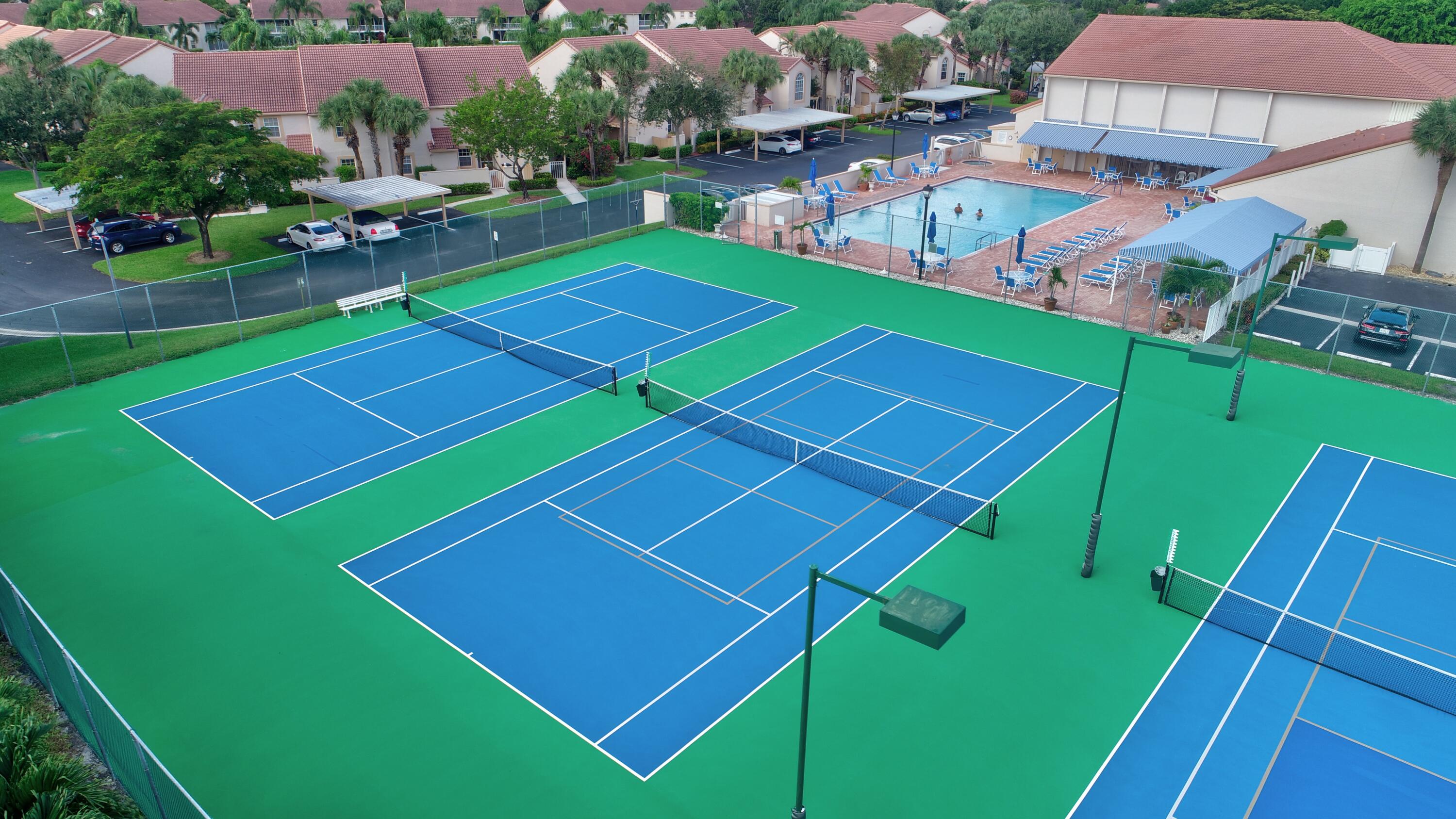7566 Red Ruby Drive Delray Beach, FL 33446 - Photo 39 of 44 a view of a tennis ground with large trees