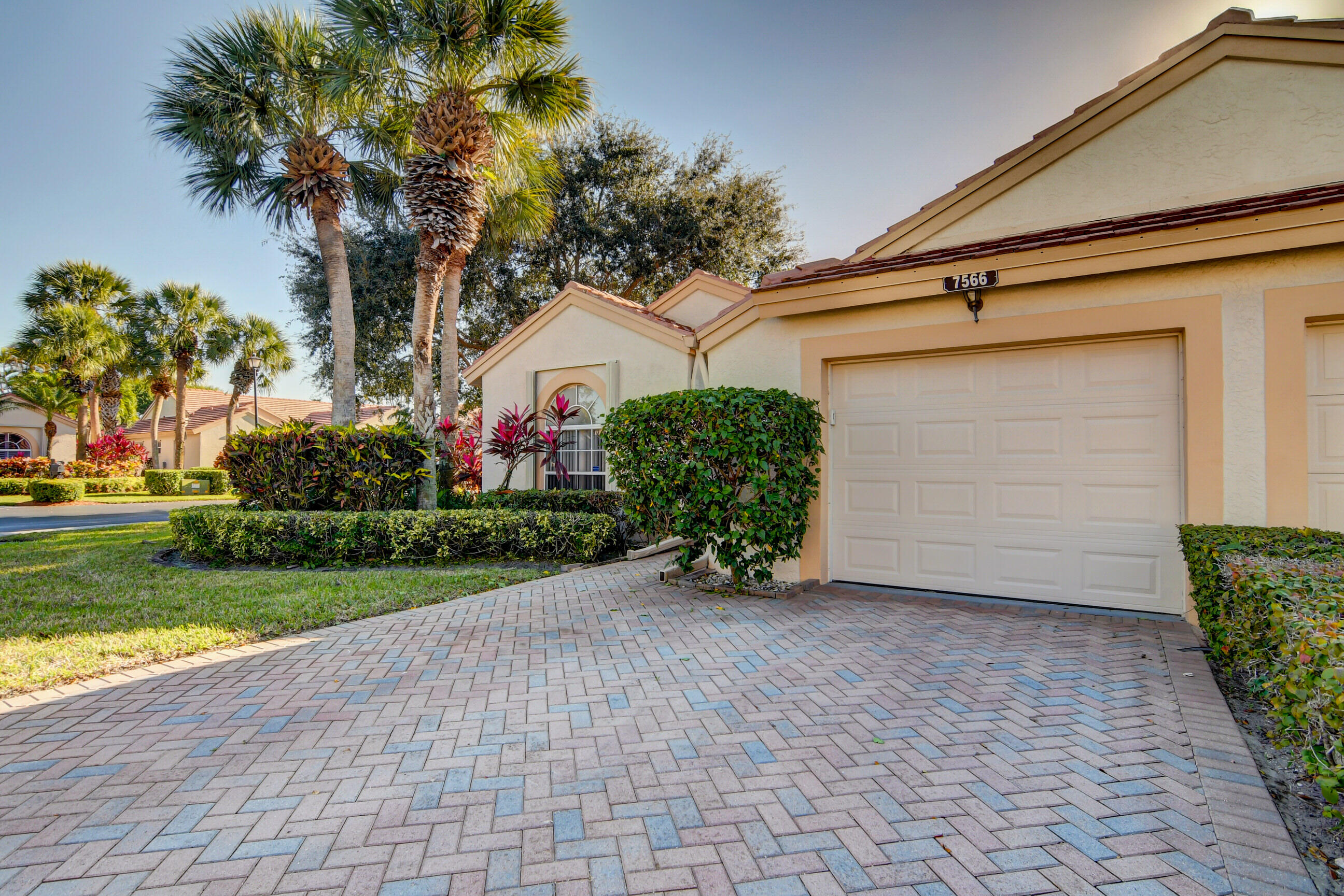 7566 Red Ruby Drive Delray Beach, FL 33446 - Photo 6 of 44 a front view of a house with garden