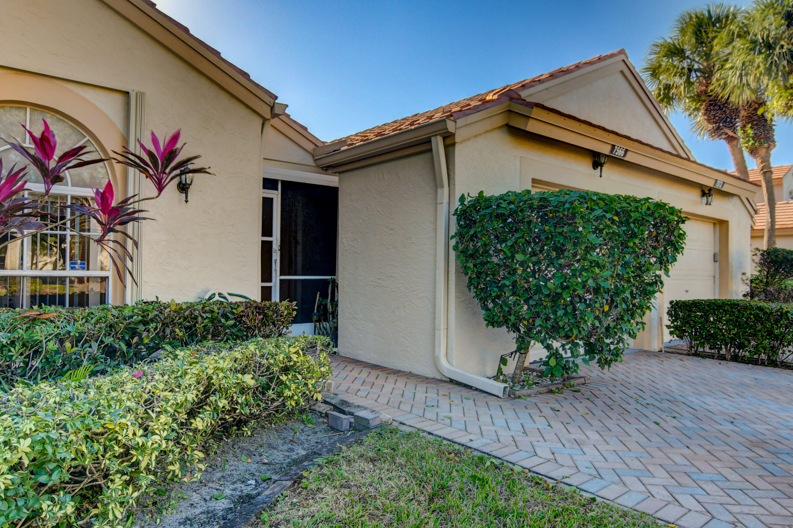 7566 Red Ruby Drive Delray Beach, FL 33446 - Photo 7 of 44 a front view of a house with garden