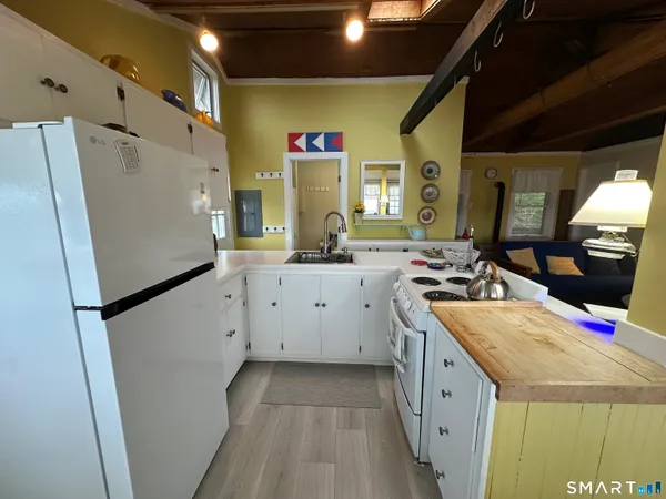 a kitchen with a sink a refrigerator and a stove