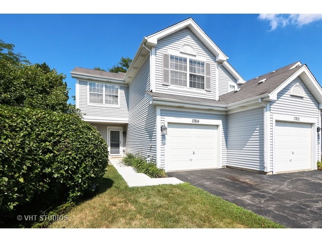17814 Braewick Road, Unit 17814 Gurnee, IL 60031 - Photo 1 of 10 a front view of a house with a yard