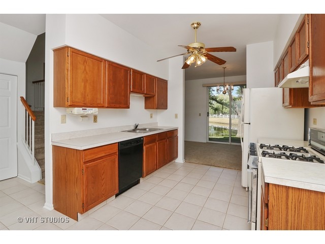 17814 Braewick Road, Unit 17814 Gurnee, IL 60031 - Photo 3 of 10 a kitchen with stainless steel appliances granite countertop a stove a sink dishwasher and a refrigerator