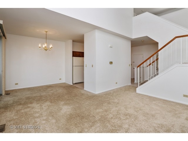 17814 Braewick Road, Unit 17814 Gurnee, IL 60031 - Photo 5 of 10 a view of an empty room with chandelier fan