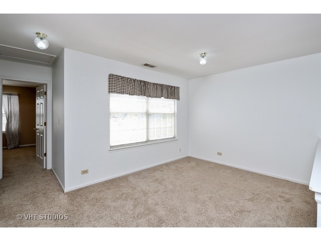 17814 Braewick Road, Unit 17814 Gurnee, IL 60031 - Photo 6 of 10 a view of an empty room with wooden floor and a window